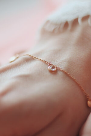 closeup-shot-female-wearing-fashionable-bracelet-with-charm-pendants