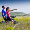 happy-young-couple-bike-ride-countryside